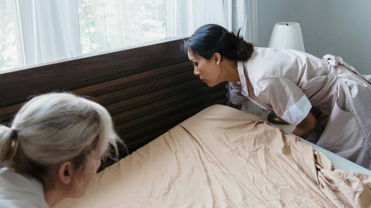 two innkeepers making a bed at a b&b